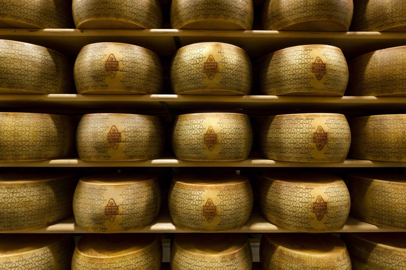 shelves stacked with Grana Padano