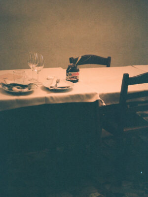 a film image of a jar of nutella on a table in a restaurant