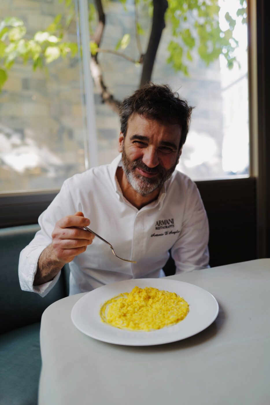 Executive Chef Antonio D’Angelo digging into saffron risotto