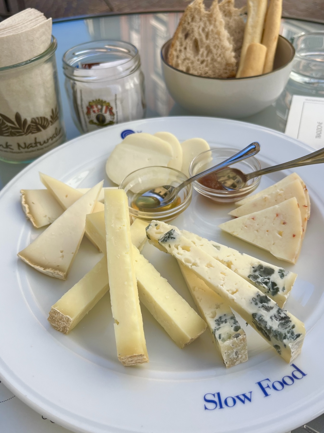 a slow food plate with assorted cheeses