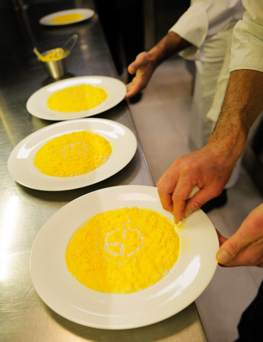 Plating of saffron risotto at armani restaurant milan