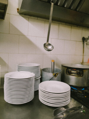 a stack of bowls in the kitchen of one of Turin's Piole