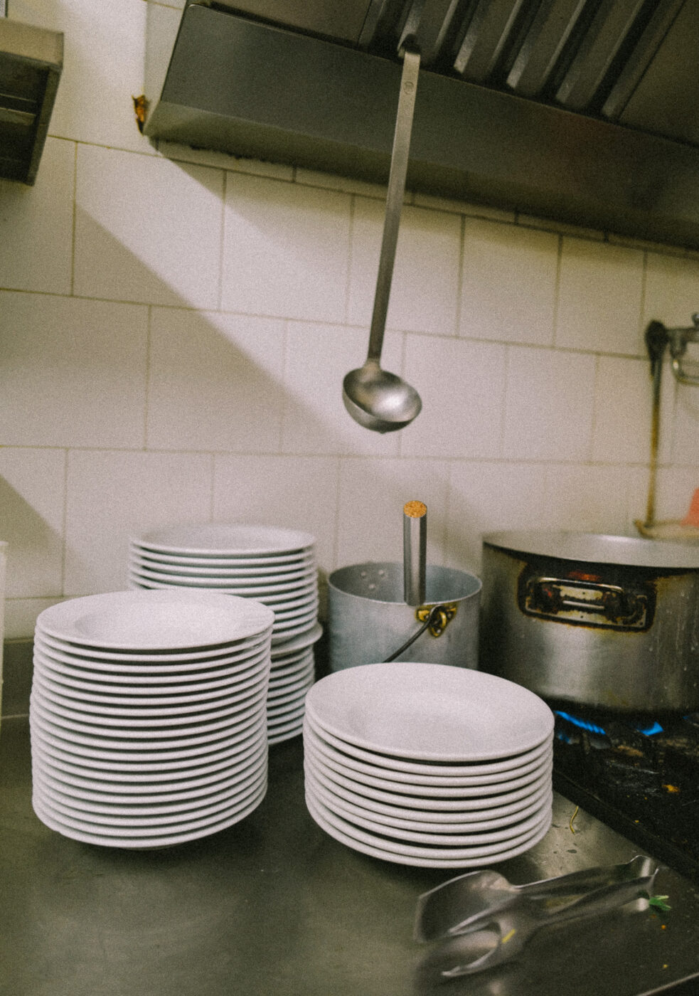 a stack of bowls in the kitchen of one of Turin's Piole
