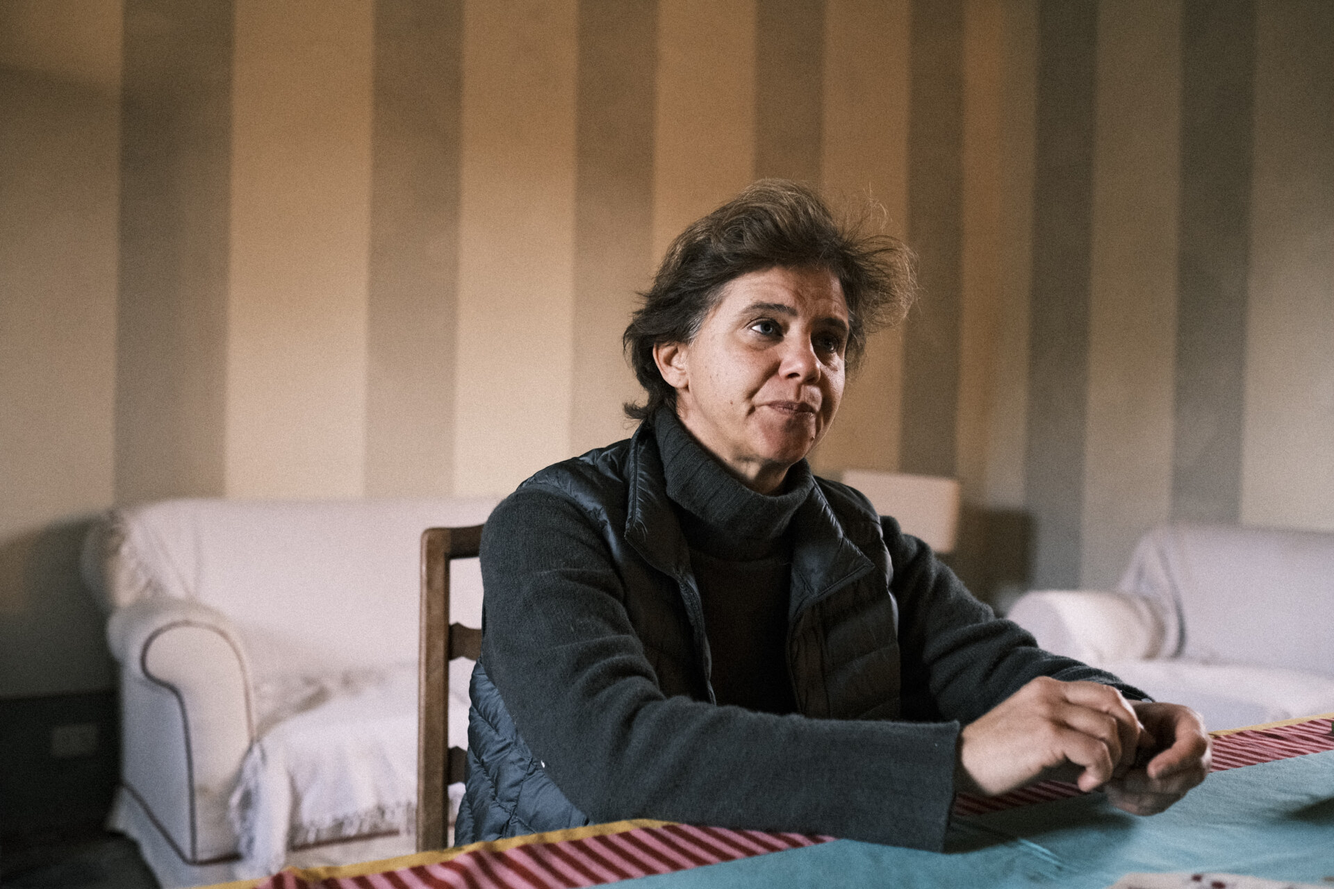 a woman sitting in her home in vercelli