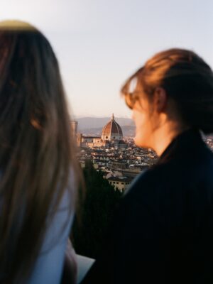 two girls look out at florence's duomo from piazzale michelangelo