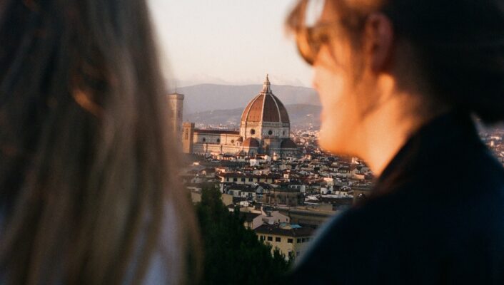 two girls look out at florence's duomo from piazzale michelangelo