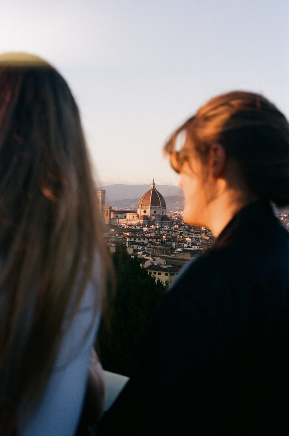 two girls look out at florence's duomo from piazzale michelangelo