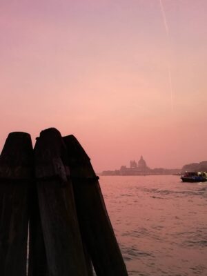 a pink sunset over giudecca island as seen from venice