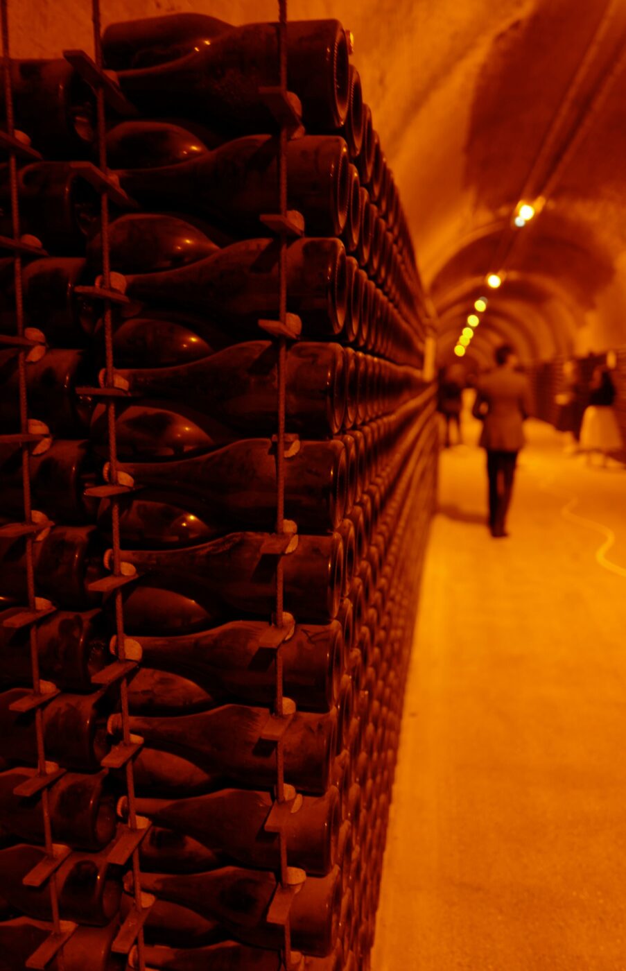 bottles of wine stacked in cellars to undergo the process of Riddling in Alta Langa