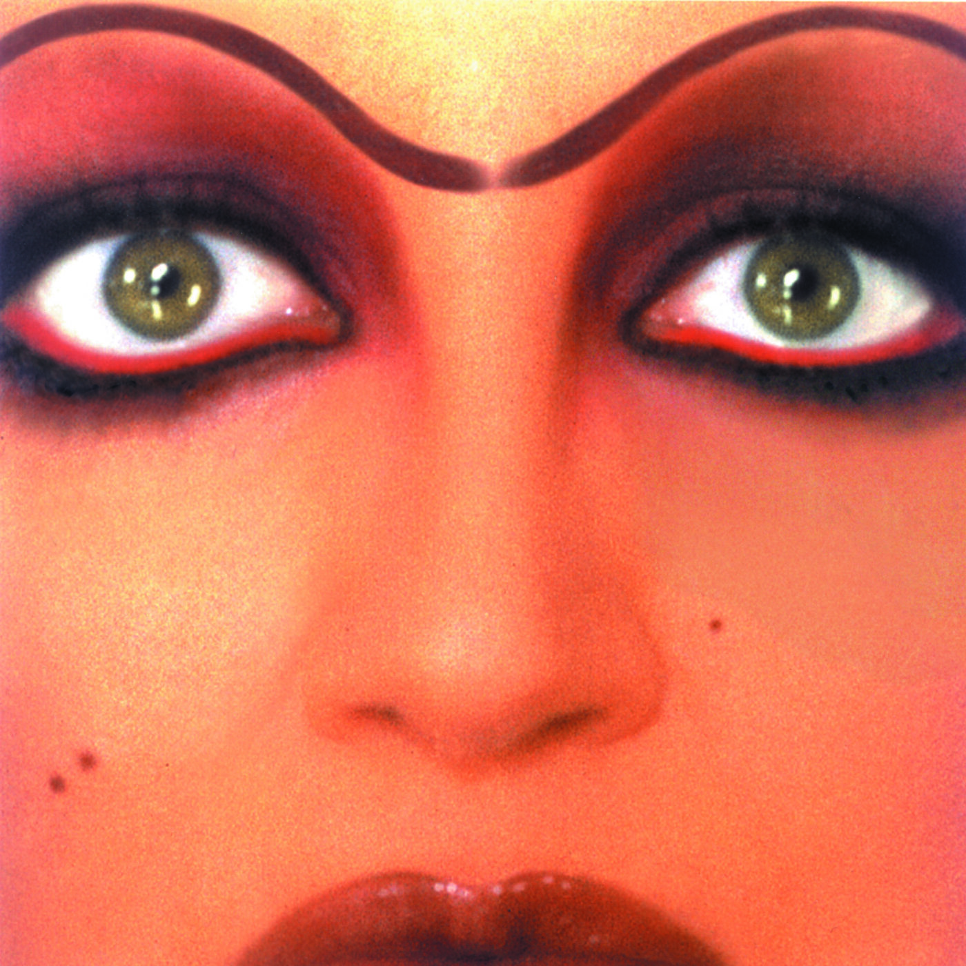 Striking Beauty - Close-up of a singer Mina with intense makeup featuring bold eyeliner, prominent eyebrows, and vibrant red eyeshadow. The lips are glossy, and the skin has a smooth texture. A beauty mark is visible on the cheek.