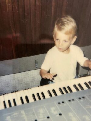 a young axel pani playing music on a keyboard
