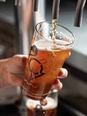 a woman serving a beer