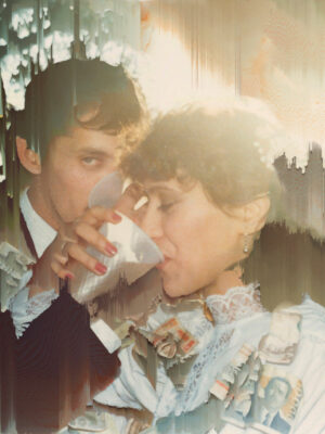 A vintage photo of a couple dressed in formal attire, with the woman drinking from a cup and the man looking at the camera. The image appears partially distorted with streaks and faded areas.