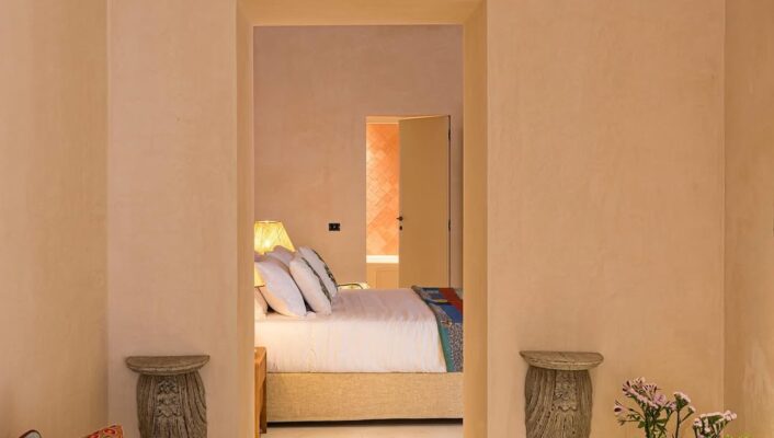 You havent specified an image title. If there is one, please provide it so I can format the alt text accordingly. If there is no image title, here’s the formatted alt text without it: A cozy, softly-lit room with a cushioned bench and colorful pillows leads to a bedroom with a bed, white bedding, and a lit lamp. Decorative wall accents and a vase of flowers add warmth and charm. If the image title is e.g. Inviting Home Interior, then per your instructions: Inviting Home Interior - A cozy, softly-lit room with a cushioned bench and colorful pillows leads to a bedroom with a bed, white bedding, and a lit lamp. Decorative wall accents and a vase of flowers add warmth and charm. Let me know if you’d like this tailored for any specific image title!.