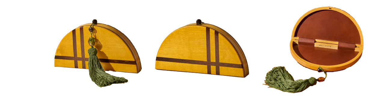A semicircular yellow clutch with dark stripes, green tassel, and wooden bead, shown closed and open to reveal a brown interior.