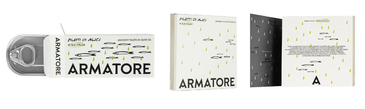 A tin of Armatore anchovy fillets in olive oil with white box, fish drawings, black/yellow text, and opened to show inside designs.
