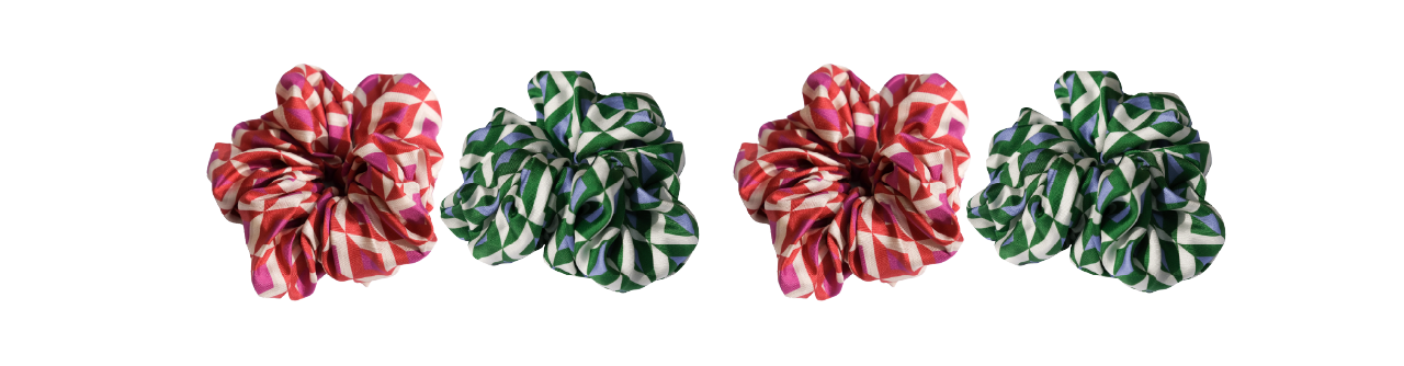 Four fabric flowers with red-and-white and green-and-white stripes are lined up in a row on a white background, alternating colors.