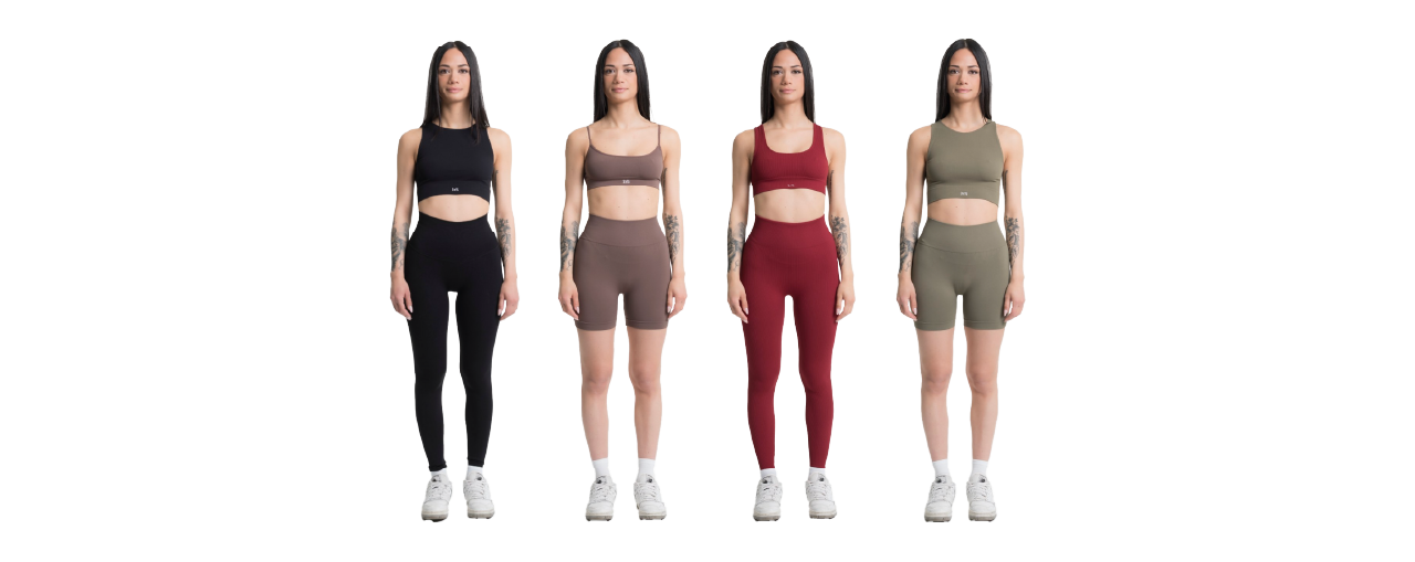 Four women with long dark hair stand in a row, each in a different colored athletic set and white sneakers, on a white background.