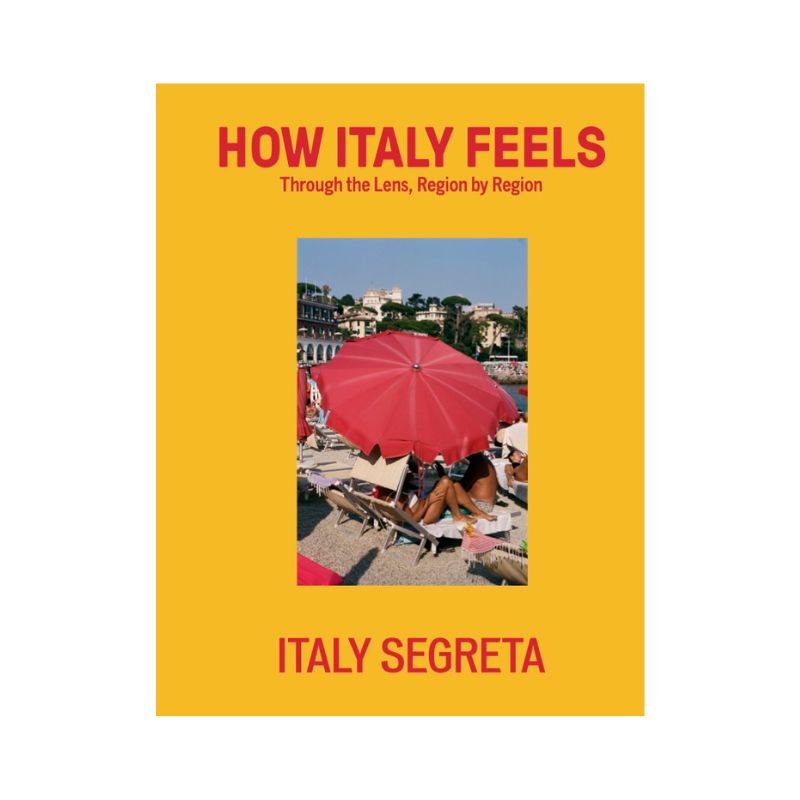 How Italy Feels - Beach scene with red umbrellas, lounge chairs on yellow background, bold red and pink text. Book cover by Italy Segreta.